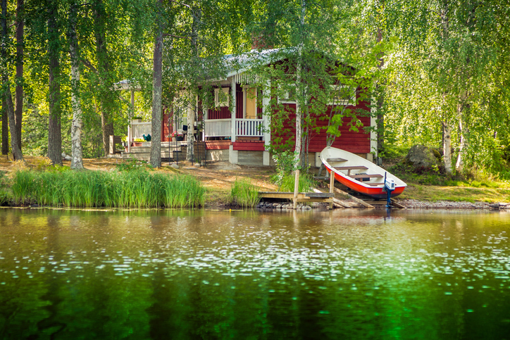cottage by a lake with a boat
